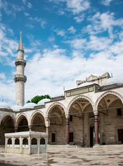 Suleymaniye Mosque in summer, Turkey. Suleymaniye Mosque is a famous landmark of Istanbul. Sunny view of courtyard of the Suleymaniye Camii. Magnificent Ottoman architecture.