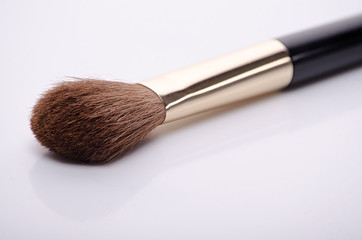 brown makeup brush with black handle isolated on white background