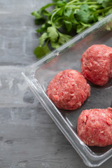 raw meatballs with pepper and salt in plastic box