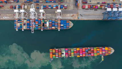 Fotobehang Rotterdam Aerial view cargo ship terminal, Unloading crane of cargo ship terminal, Aerial view industrial port with containers and container ship.  © Kalyakan