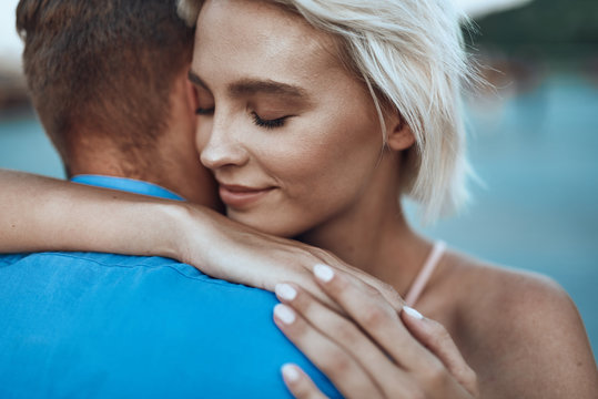 Smiling Lady Putting Her Arms Around Neck Of Beloved Man