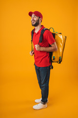 Image of smiling delivery man in red uniform carrying backpack with takeaway food