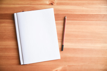 wooden table. copy space. book. planning, plan, writer, author, novelist. Opened notepad with papers scattered on the table, concept search, generation of ideas.