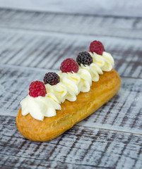 eclairs with vanilla cream cheese decorated with fresh berries
