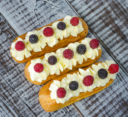eclairs with vanilla cream cheese decorated with fresh berries