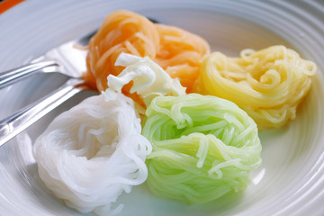Colorful Thai rice noodles in dish ready to serve.