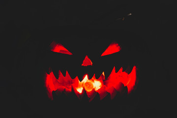 scary pumpkin for Halloween on a black background