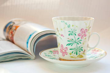 Coffee mug with newspaper on teal rustic table, cozy breakfast, vintage style