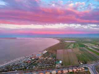 The incredible sunset over L'Ampolla and Deltebre, Catalonia, Spain. Drone aerial photo