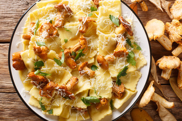 Italian ravioli with chanterelles and parmesan cheese close-up on a plate. horizontal top view