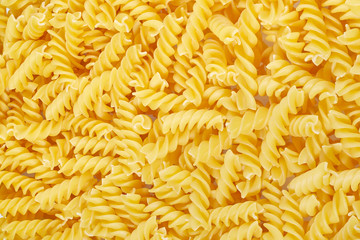 Background of pasta in a spiral of yellow color.
