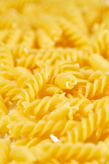 Background of pasta in a spiral of yellow color.