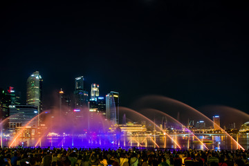 Fototapeta na wymiar Spectra Light and Water Show Marina Bay Sand Casino Hotel Downtown Singapore