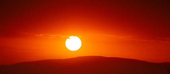 Beautiful sunset sky above clouds with dramatic light.