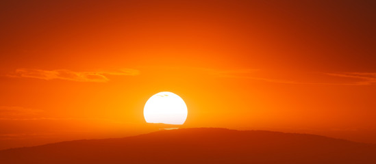 Beautiful sunset sky above clouds with dramatic light.