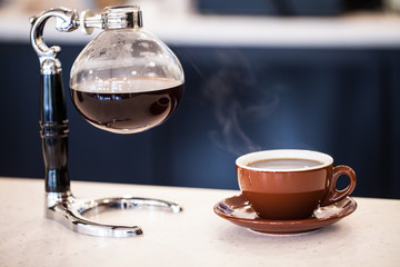Syphon pot and cup of coffee
