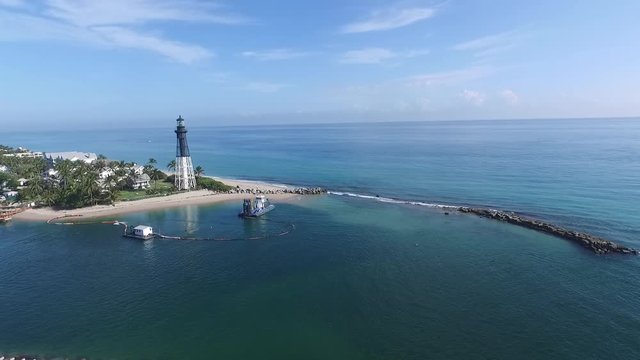 Peaceful coastline panorama with lighthouse and yacht 
