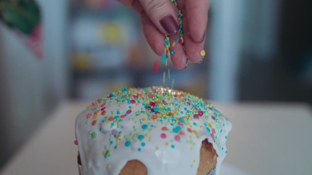 Powdering an Easter cake with colored caramel. 4K