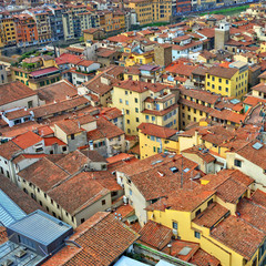 Fototapeta na wymiar Aerial view. Nice buildings with red tile roofs in the old city. Italian culture and architecture. Urban landscape. Italy, Florence