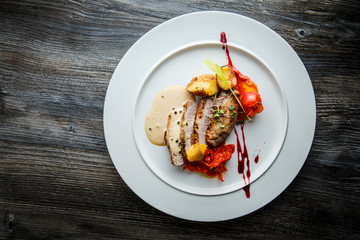 top view of delicious sliced baked meat with sauces