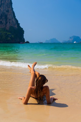 Fototapeta na wymiar Cute woman relaxing on the summer beach.