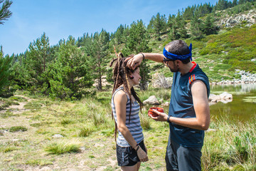 man and woman eat cherries on the mountain