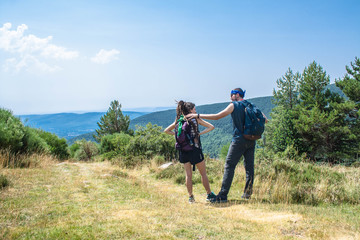 man and woman talk about their route in the mountain