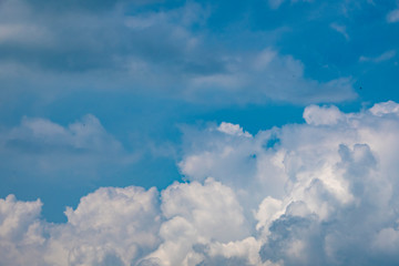 Naklejka na ściany i meble White clouds on the blue sky. Abstract background with clouds on blue sky. In the clear sky high floating clouds.