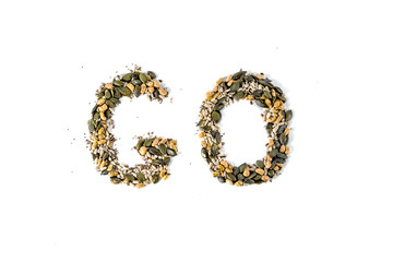 Word GO lined with mixed seed and nut isolated on white background