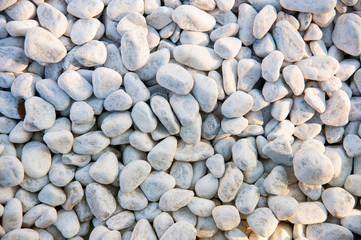Light small stones, top view on a beautiful background of small pebbles