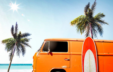 A red orange vintage van in the ocean and sunny beach view. Summer time and fun on the beach.