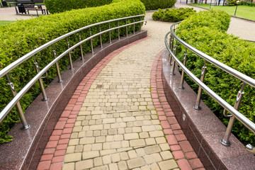 walkway with chrome steel railings in landscape design