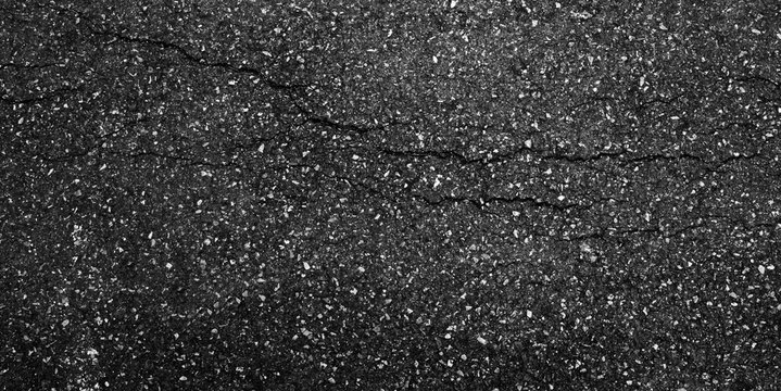 crack and texture of asphalt road - top view background.