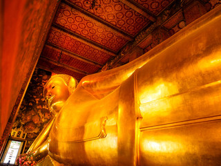 Beautiful face of Reclining Buddha, and thai art architecture in Wat Phra Chetupon Vimolmangklararm...