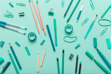 Flat lay of office, school stationery on green background