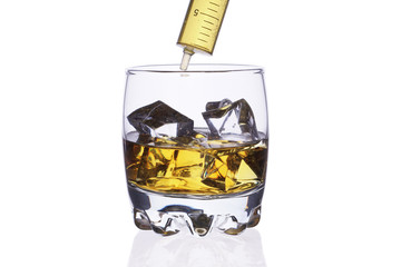 A glass of whiskey with ice cubes on a white background.