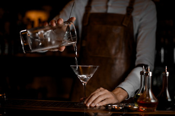 Bartender pouring an alcohol drink from jar