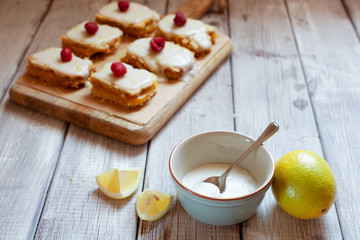 Lemon frosting in blue bowl for decoration cakes close up