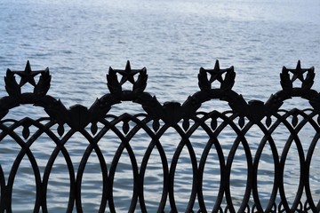 peaks at the forged fence in the form of stars, pond