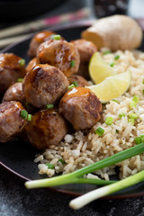 Close-up of pan fried pork meatballs with rice, vertical shot, selective focus