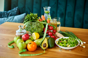 Diet weight loss breakfast concept with tape measure, organic fruits , vegetables, salad and fresh water. Healthy nutrition concept, Lifestyle and Eating