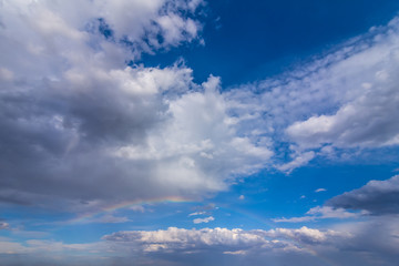 Fototapeta na wymiar beautiful blue cloudy sky with rainbow after a rain, natural background