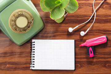 aqua old retro phone, empty notebook and earphones, felt pen 