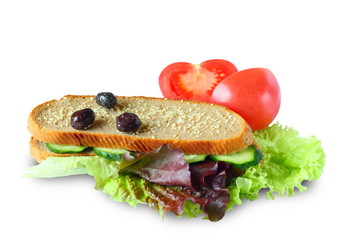 sandwich with lettuce, cucumbers, olives, tomatoes.