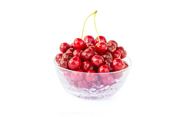 Fresh sweet red cherries in a glass bowl, ripe and juicy cherry fruit, healthy food, close-up, isolated on a white