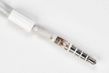 Fototapeta premium A broken headphone jack on white background.