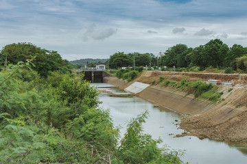 Fototapeta premium Irrigation canal or irrigation channel in concrete wall Send water from the reservoir to the agricultural area of ​​the farmer that is dry in the rainy season of Thailand. 