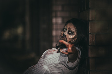 Portrait of asian woman make up ghost face with blood,Horror scene,Scary background,Halloween poster,Thailand people