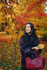 stylish girl exploring the city and park in the autumn