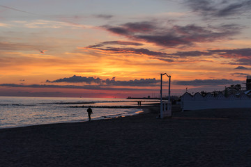 Fototapeta na wymiar Sunset on the beach in Ostia Lido, Roma, Italy